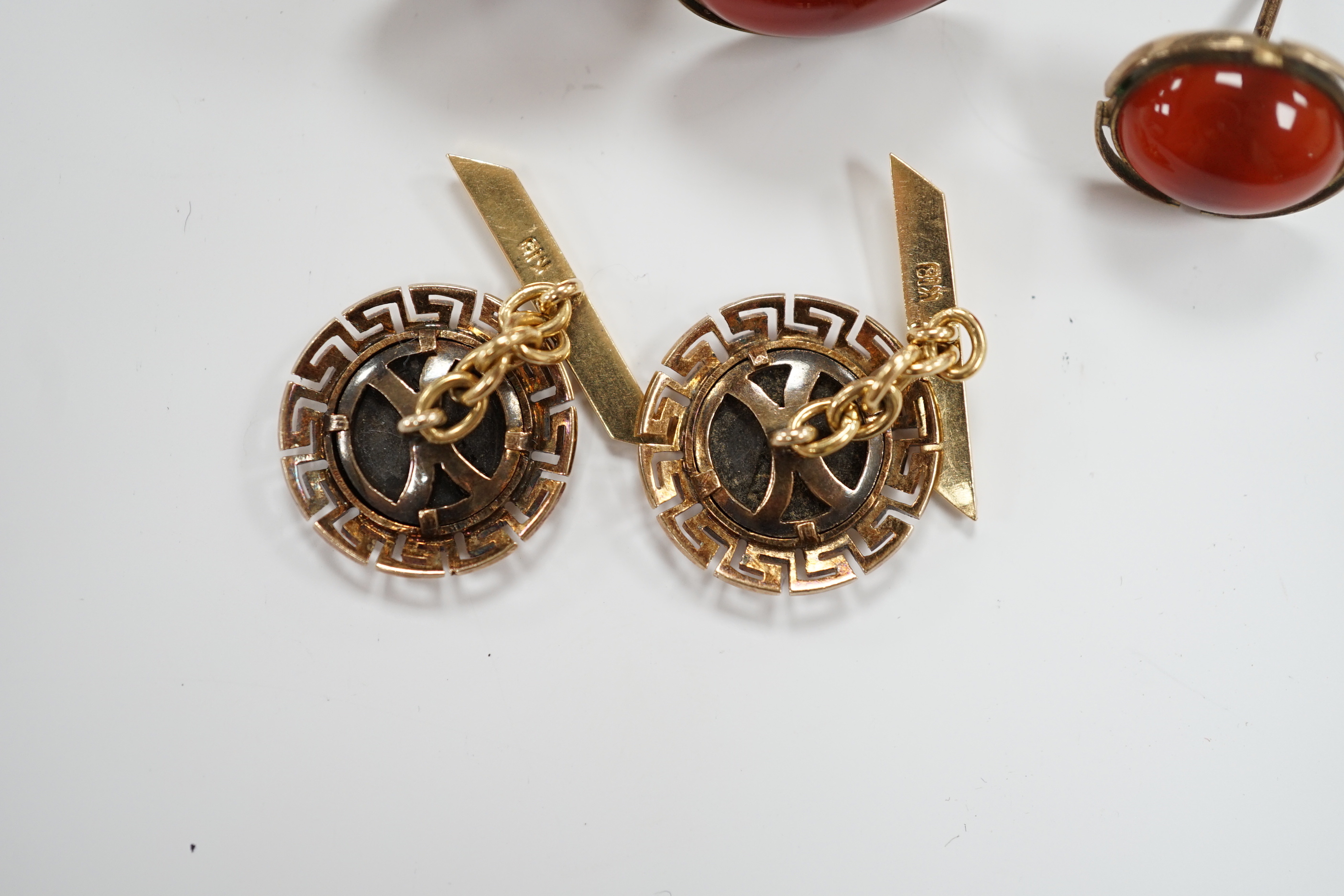 A pair of 18k and white metal 'Parthenon' circular cufflinks, with Greek Key border, 17mm, gross 8.9 grams, a pair of 10k and cabochon cufflinks and an earring.